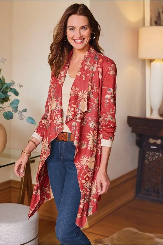 The faux suede jacket in the floral print, worn open over jeans